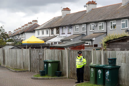 A police officer stands on duty at the back of a property being searched after a man was arrested in connection with an explosion on a London Underground train, in Sunbury-on-Thames, Britain, September 17, 2017. REUTERS/Peter Nicholls