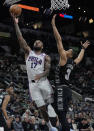 Philadelphia 76ers forward P.J. Tucker (17) drives to the basket past San Antonio Spurs forward Keldon Johnson (3) during the first half of an NBA basketball game in San Antonio, Friday, Feb. 3, 2023. (AP Photo/Eric Gay)