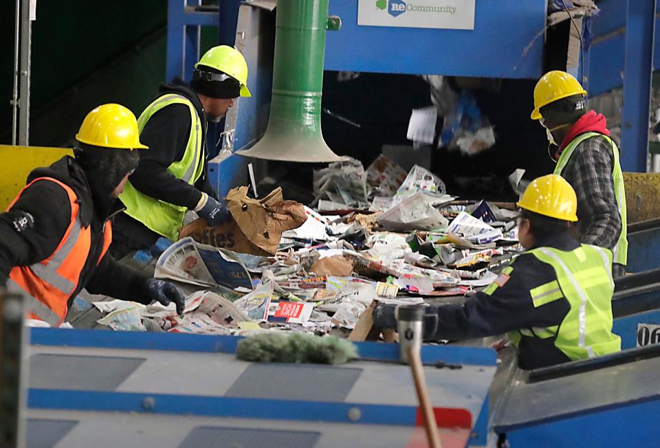 Workers quickly sort and remove items that cannot be recycled from a fast-moving belt at the recycling center in the Menomonee Valley that is jointly owned by the City of Milwaukee and 27 Waukesha County municipalities. Much of their work involves removing items people are not supposed to put into their recycling bins, mainly plastic bags that contain other items.