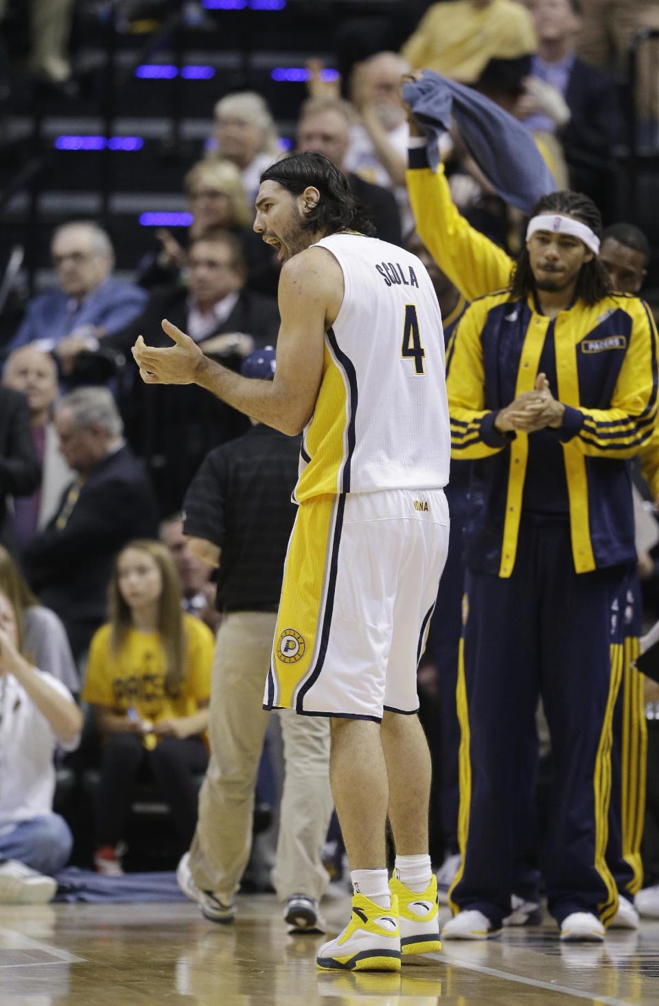 Indiana Pacers' Luis Scola (4) encourages his teammates during the first half in Game 2 of an opening-round NBA basketball playoff series against the Atlanta Hawks Tuesday, April 22, 2014, in Indianapolis. (AP Photo/Darron Cummings)