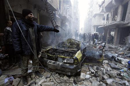 Residents look for survivors at a damaged site after what activists said was an air strike from forces loyal to Syria's President Bashar al-Assad in Takeek Al-Bab area of Aleppo