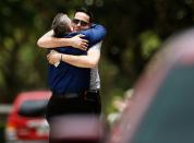 <p>Two mourners embrace ahead of the funeral of Kimberly Morris in Kissimmee, Fla. <em>(Photo: Carlo Allegri/Reuters)</em> </p>