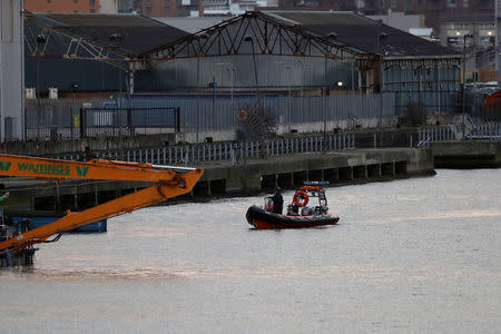 A bomb disposal team stand on a boat on near London City Airport, in London, Britain February 12, 2018. REUTERS/Simon Dawson