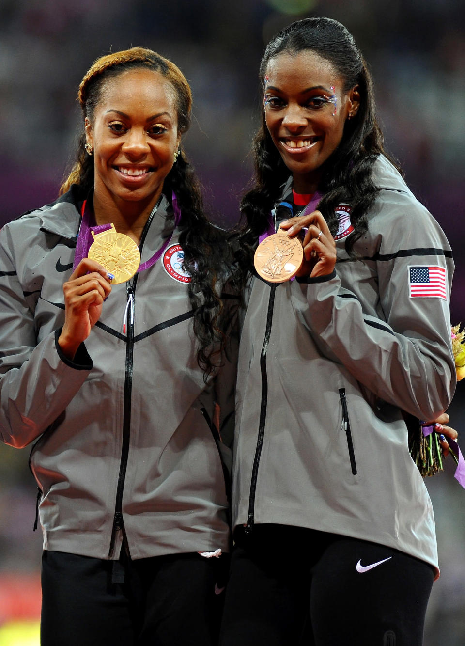 (L-R) Gold medalist <a href="http://sports.yahoo.com/olympics/track-field/sanya-richards-ross-1130538/" data-ylk="slk:Sanya Richards-Ross;elm:context_link;itc:0;sec:content-canvas" class="link ">Sanya Richards-Ross</a> and bronze medalist <a href="http://sports.yahoo.com/olympics/track-field/deedee-trotter-1131834/" data-ylk="slk:DeeDee Trotter;elm:context_link;itc:0;sec:content-canvas" class="link ">DeeDee Trotter</a> of the United States pose on the podium during the medal ceremony for the Women's 400m Final on Day 9 of the London 2012 Olympic Games at the Olympic Stadium on August 5, 2012 in London, England. (Photo by Mike Hewitt/Getty Images)