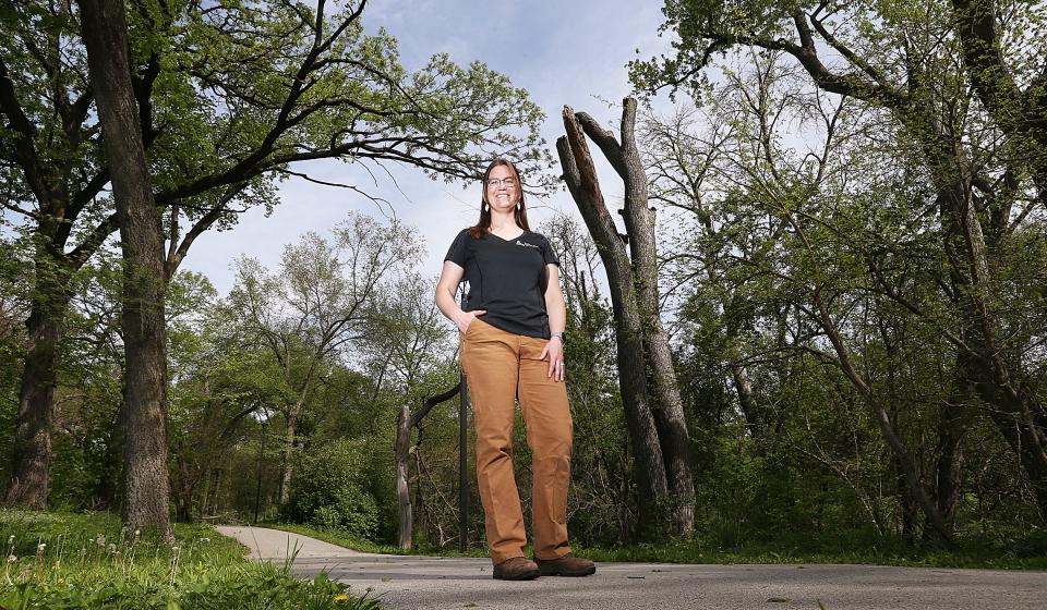 Gabriele Edwards, the Ames city forester, takes a moment to pose with her most trusted constituents, the trees of Brookside Park on Thursday, May 11. Over her shoulder is a silver maple tree that was converted into wildlife habitat rather than being completely taken down for safety.