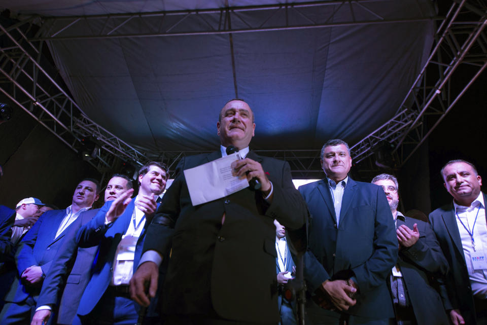 Alejandro Giammattei, presidential candidate of the Vamos party, stands before supporters after partial election results were announced in Guatemala City, Sunday, Aug. 11, 2019. Giammattei headed for a victory in Sunday’s presidential runoff election, garnering favor with voters for his get-tough approach on crime and socially conservative values. (AP Photo/ Santiago Billy)