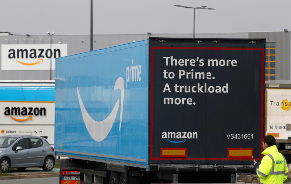 A truck with the logo of Amazon Prime Delivery arrives at the Amazon logistics center in Lauwin-Planque, northern France, March 19, 2020. Several hundred employees protested in France, calling on the U.S. e-commerce giant to halt operations or make it easier for employees to stay away during the coronavirus (COVID-19) epidemic. REUTERS/Pascal Rossignol