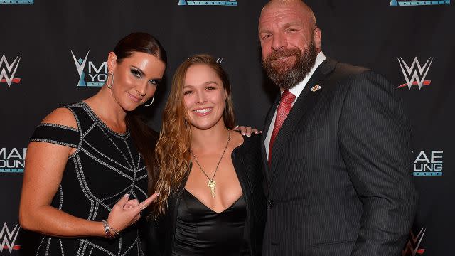 Rousey with WWE bosses Stephanie McMahon and Triple H. Image: Getty