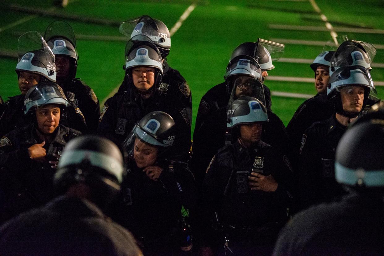 <span>Police gather near a pro-Palestinian encampment at Columbia University on 30 April 2024.</span><span>Photograph: Marco Postigo Storel via AP</span>