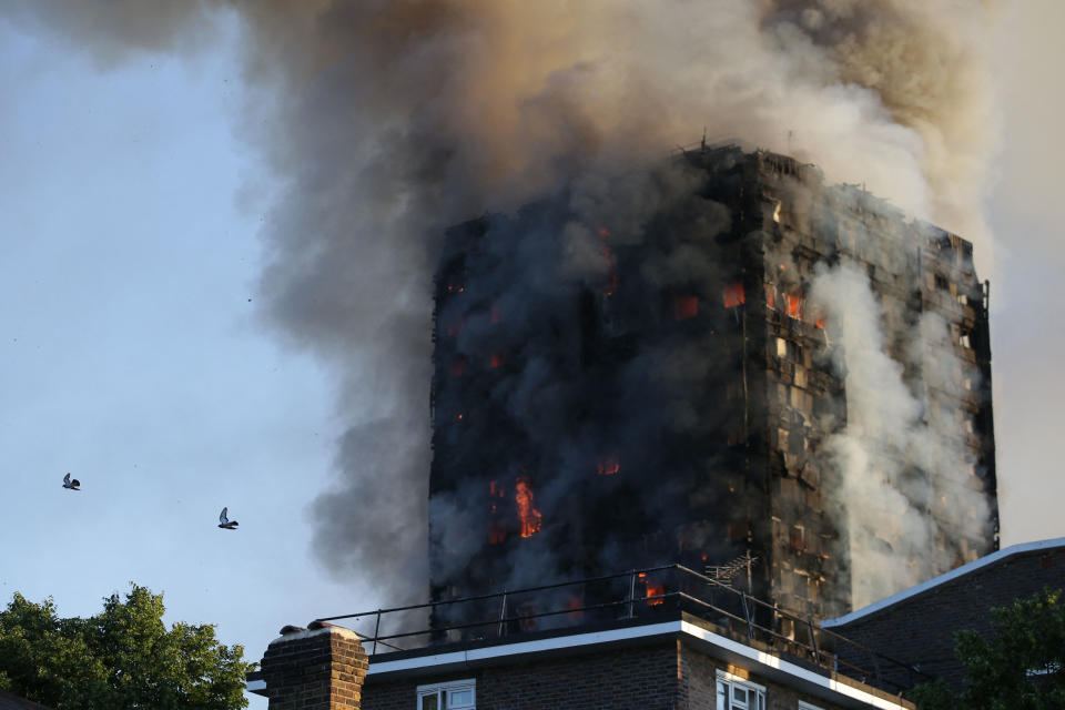 Smoke billows from Grenfell Tower as firefighters attempt to control a huge blaze on June 14, 2017 in west London. The massive fire ripped through the 27-storey apartment block in west London in the early hours of Wednesday, trapping residents inside as 200 firefighters battled the blaze. Police and fire services attempted to evacuate the concrete block and said 