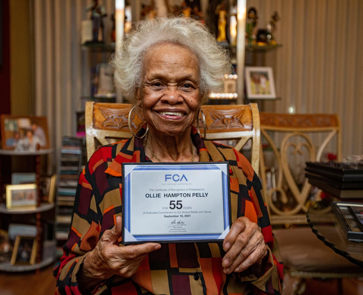 Ollie Mae Hampton Pelly poses Wednesday, Jan. 4, 2023, inside her Beloit, Wisconsin, home with her 55-year anniversary certificate she received from Chrysler in September 2021.