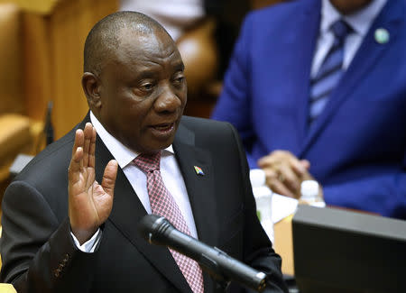 President Cyril Ramaphosa takes an oath as he is sworn in as a Member of Parliament in Cape Town, South Africa, May 22, 2019. REUTERS/Sumaya Hisham