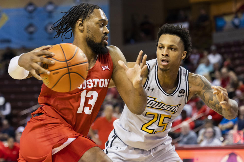 Houston's J'Wan Roberts (13) drives against Towson's Messiah Jones (25) during the first half of an NCAA college basketball game in the Charleston Classic in Charleston, S.C., Thursday, Nov. 16, 2023. (AP Photo/Mic Smith)