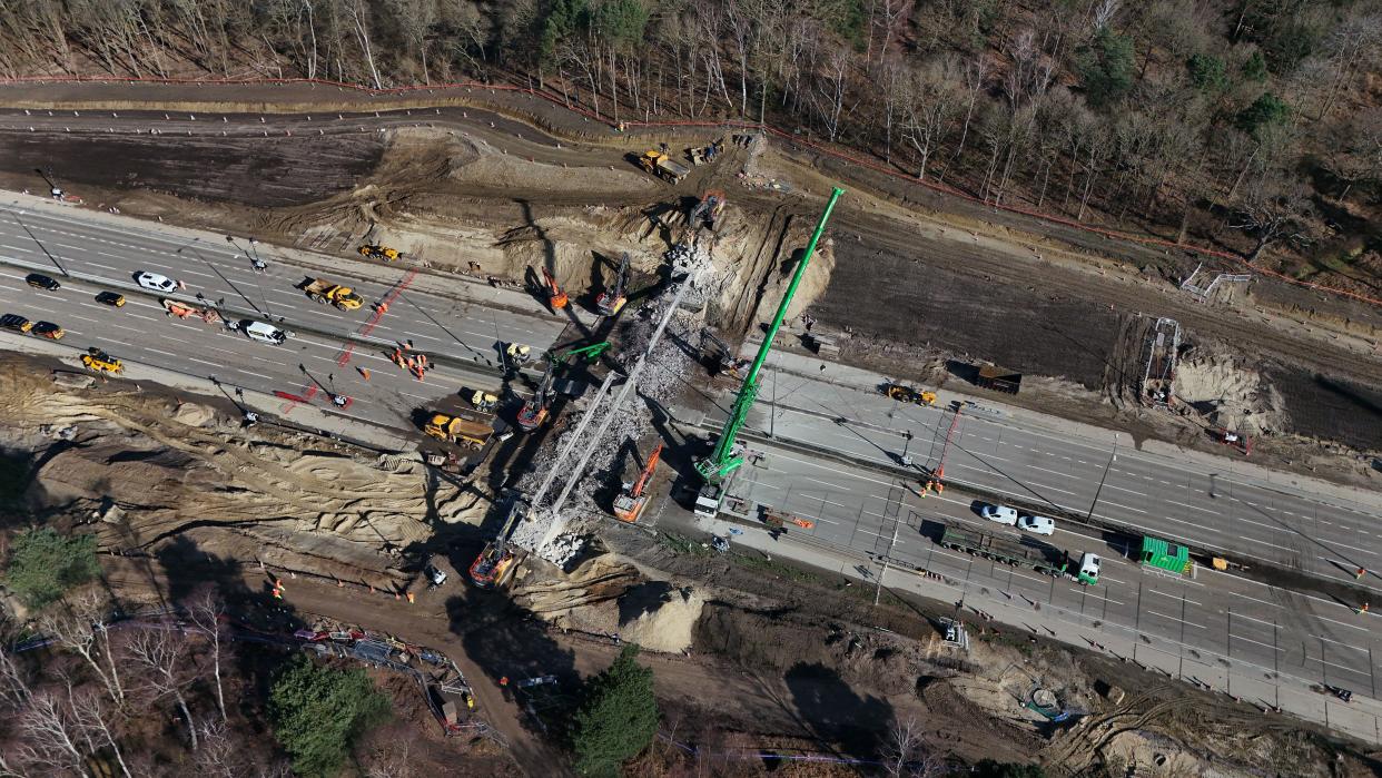 Workman on the section of the M25 between Junctions 10 and 11, in Surrey, that is closed in both directions while a bridge is demolished and a new gantry is installed. Picture date: Saturday March 16, 2024.