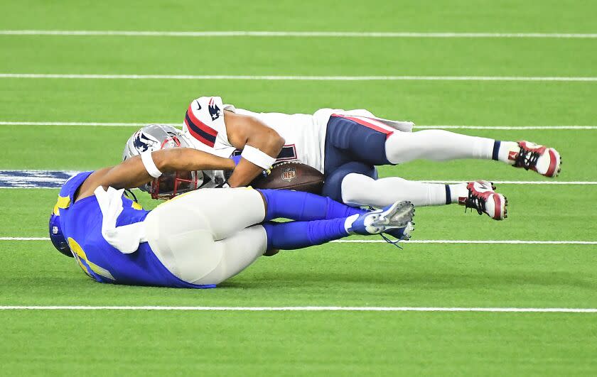 INGLEWOOD, CALIFORNIA DECEMBER 10, 2020-Patriots defensive back Myles Bryant takes the ball away from Rams reeiver Robert Woods for an interception in the 1st quarter at SoFi Stadium Thursday. (Los Angeles Times/Wally Skalij)