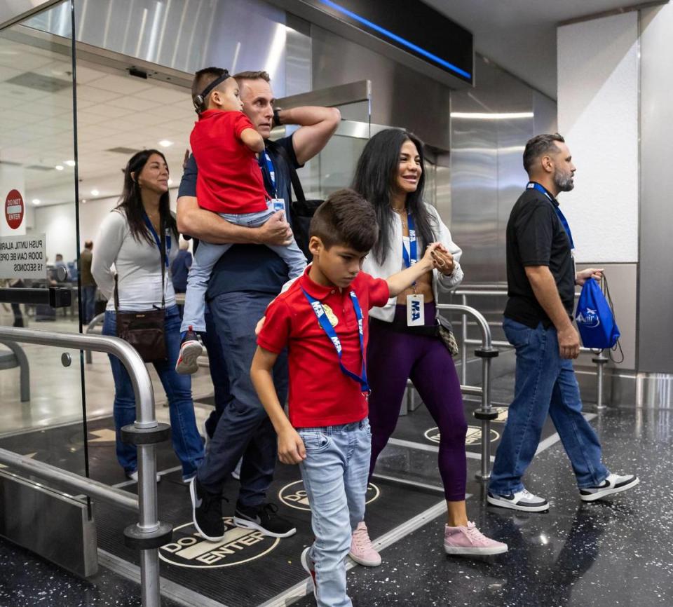 From left to right: Parker Hansen, 5, Paul Hansen, Cooper Hansen, 7, and Carol Hansen participate in the MIAair tour at the Miami International Airport on Monday, Oct. 23, 2023, in Miami, Fla. The MIA Airport Instruction and Readiness tour allows more than 30 children with special needs to walk through an airport travel experience from start to finish in a safe and controlled environment. MATIAS J. OCNER/mocner@miamiherald.com