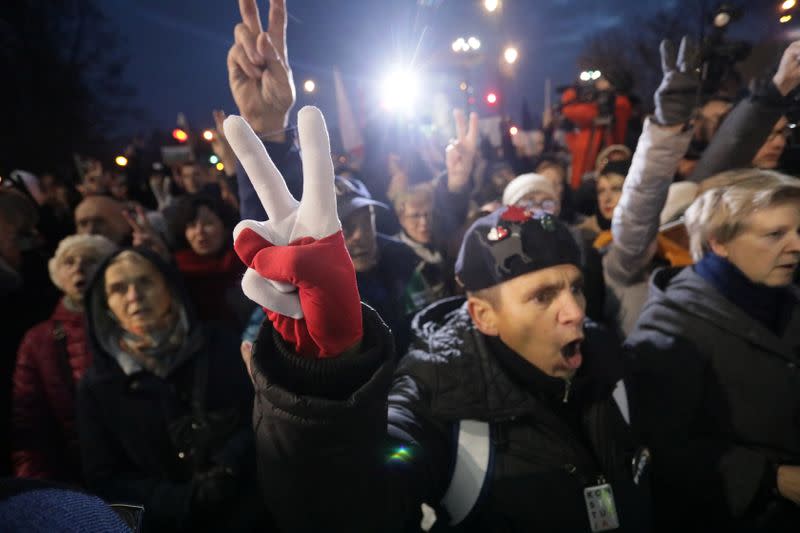 People take part in an anti-government protest in support of free judiciary in Warsaw