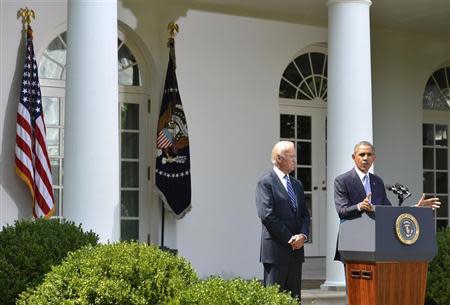 U.S. President Barack Obama speaks next to Vice President Joe Biden (L) at the Rose Garden of the White House August 31, 2013, in Washington. REUTERS/Mike Theiler