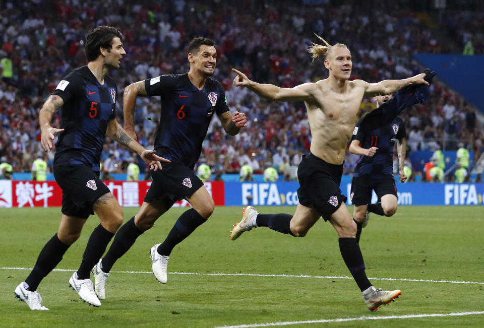 Croatia’s Domagoj Vida, right, celebrates with his teammates after scoring his side’s second goal during the quarterfinal match between Russia and Croatia at the 2018 World Cup. (AP)