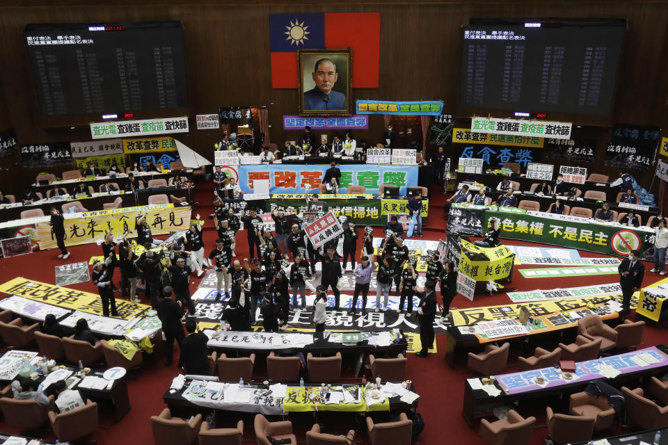 Supporters for both ruling and opposition parties demonstrate at the legislative chamber building in Taipei, Taiwan, Tuesday, May 28, 2024. (AP Photo/Chiang Ying-ying)