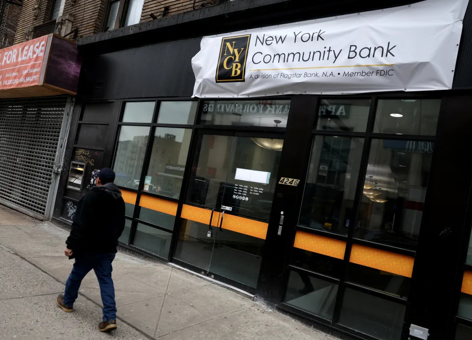 A man walks past a closed branch of the New York Community Bank in New York City, U.S., January 31, 2024. REUTERS/Mike Segar/File Photo