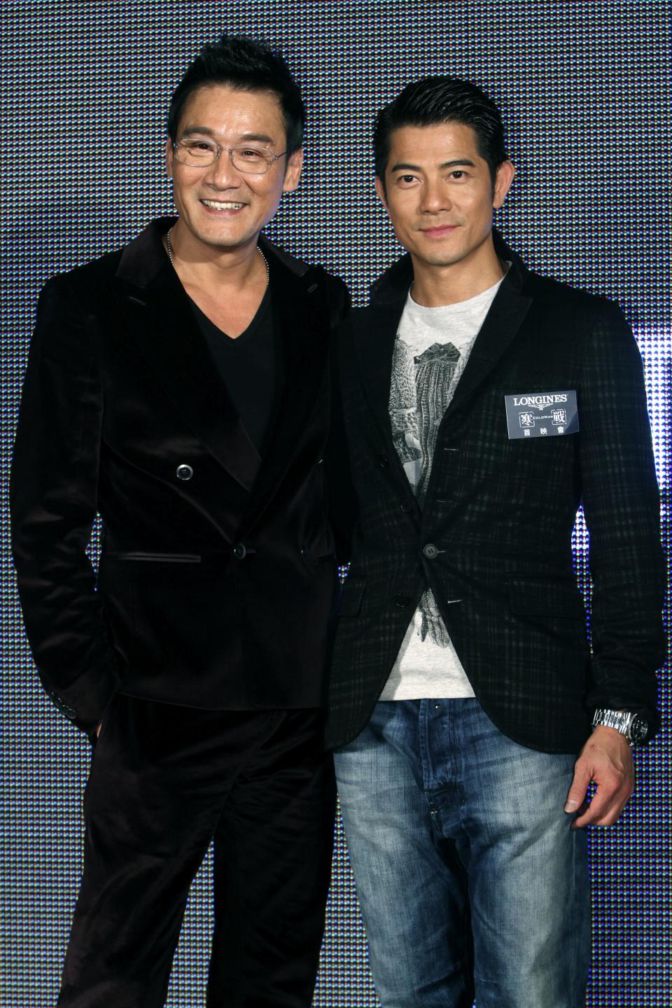 In this photo taken on Monday, Nov. 12, 2012, Hong Kong actors Aaron Kwok, right, and Tony Leung Ka Fai pose for the media during a promotional event for their new film "Cold War" in Taipei, Taiwan. (AP Photo/Chiang Ying-ying)