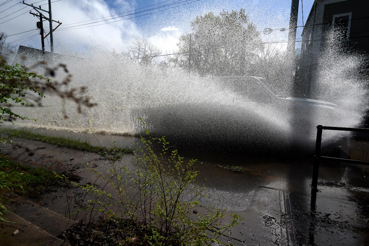 Vehicles travel south along Eastern Avenue through water pooled on the road, Tuesday, April 2, 2024, in the Linwood neighborhood of Cincinnati. Rain and thunderstorms passed through the morning while more rain and possible tornado activity possible through 8 p.m. Tuesday.