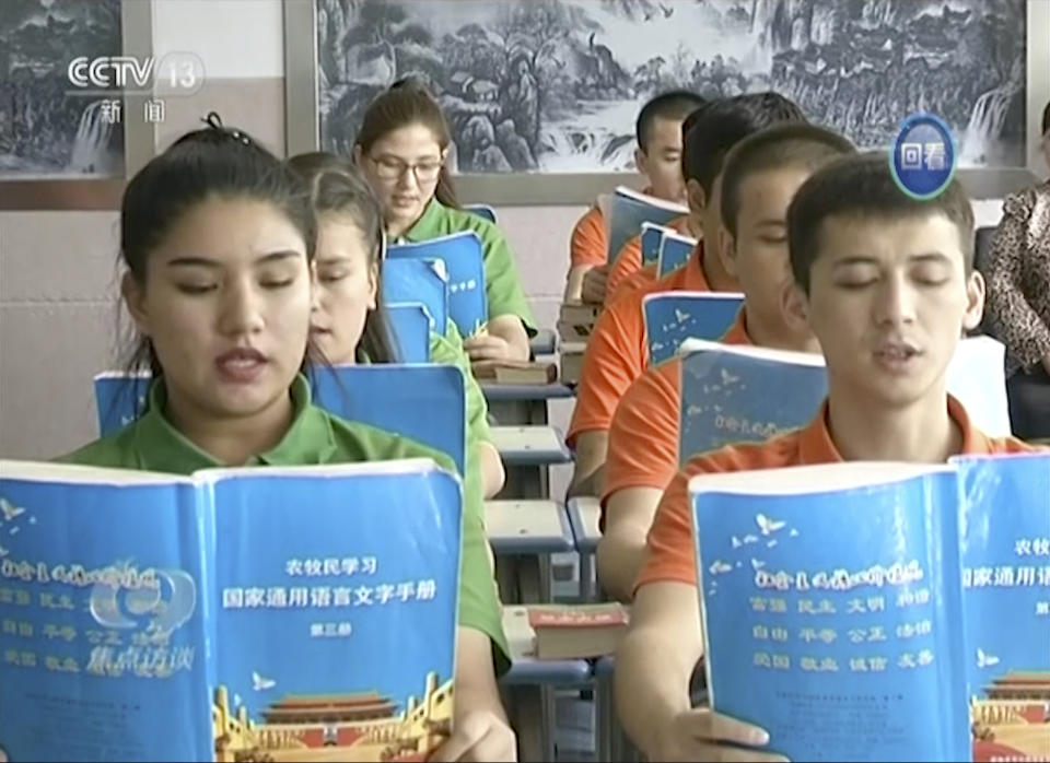 In this image from undated video footage run by China’s CCTV via AP Video, young Muslims read from official Chinese language textbooks in classrooms at the Hotan Vocational Education and Training Center in Hotan, Xinjiang, northwest China. (AP)