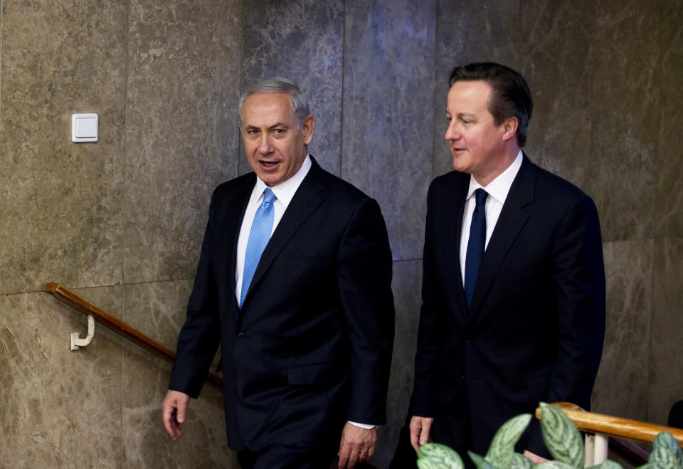 British Prime Minister David Cameron, right, walks with his Israeli counterpart Benjamin Netanyahu before delivering joint statements in Jerusalem on Wednesday, March 12, 2014. Cameron made his first visit as British leader to Israel and plans to visit the Palestinian territories this week. (AP Photo/Ronen Zvulun, Pool)