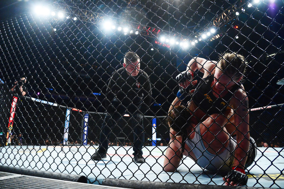 Sep 25, 2021; Las Vegas, Nevada, USA; Valentina Shevchenko pins Lauren Murphy to the cage/ during UFC 266 at T-Mobile Arena. Mandatory Credit: Gary A. Vasquez-USA TODAY Sports