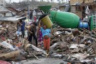 Residents walk past devastated houses after super typhoon Haiyan hit Tacloban city, central Philippines November 11, 2013.