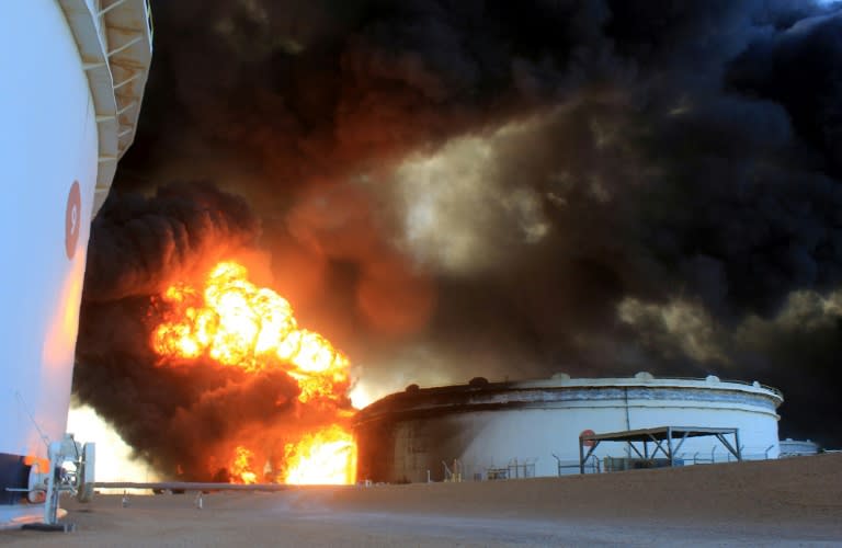 Flames rise from a storage tank at the key Libyan oil port of Ras Lanuf region after it was set ablaze during an attack by the Islamic State group on January 21, 2016