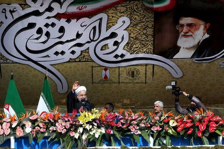 Iranian President Hassan Rouhani waves as he delivers a speech during a ceremony marking the 37th anniversary of the Islamic Revolution, in Tehran's Azadi (liberty) Square February 11, 2016. REUTERS/President.ir/Handout via Reuters