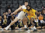 Long Beach State guard Marcus Tsohonis, right, defends the ball from UC Davis guard Leo DeBruhl during the first half of an NCAA college basketball game in the championship of the Big West Conference men's tournament Saturday, March 16, 2024, in Henderson, Nev. (AP Photo/Ronda Churchill)