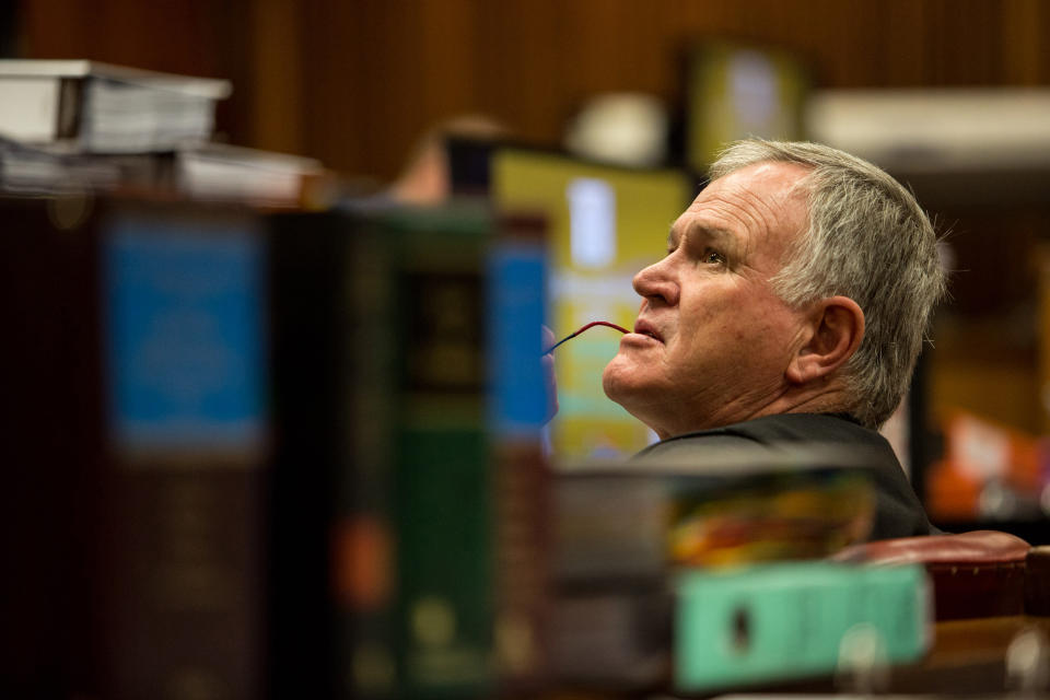 Barry Roux, defense attorney for Oscar Pistorius, sits inside court in Pretoria, South Africa, Monday, March 17, 2014. Pistorius is on trial for the murder of his girlfriend Reeva Steenkamp on Valentine's Day, 2013. (AP Photo/Daniel Born, Pool)