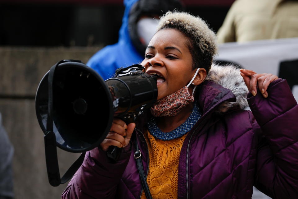 Community activist India Walton speaks through a megaphone as she campaigns in Buffalo, New York.