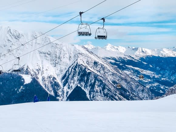 Ski lift operating in snowy mountains.