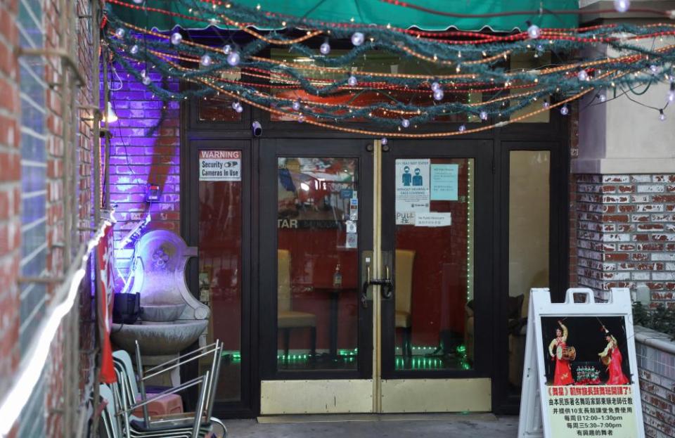 The entrance of a business is festooned with strings of lights.