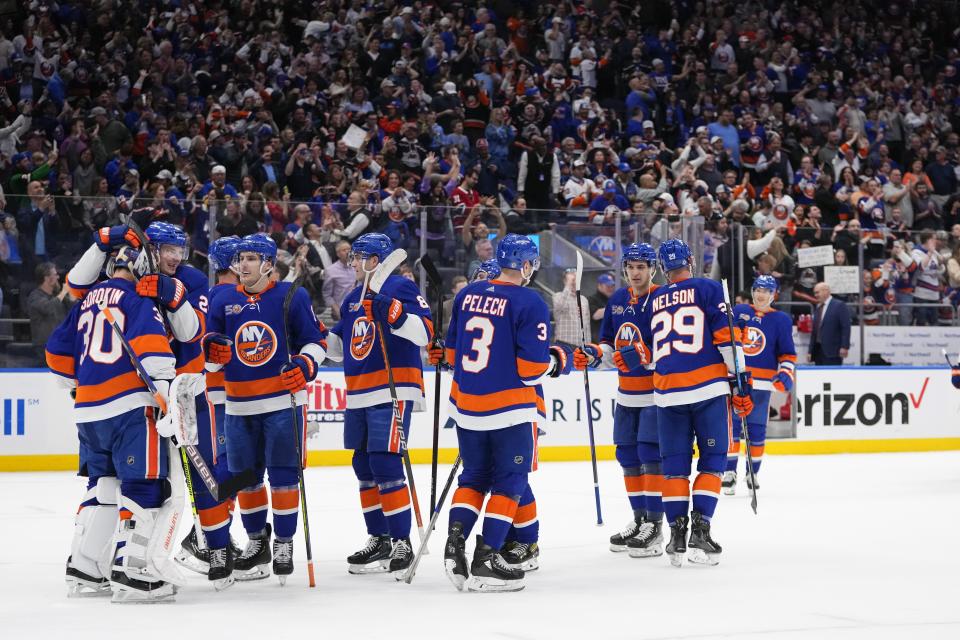 New York Islanders goaltender Ilya Sorokin (30) celebrates with teammates after an NHL hockey game against the Montreal Canadiens on Wednesday, April 12, 2023, in Elmont, N.Y. The Islanders won 4-2. (AP Photo/Frank Franklin II)