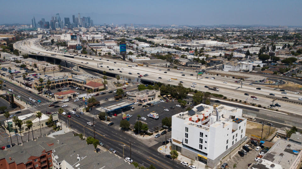 An aerial view of the RISE Apartments, an affordable apartment community for homeless veterans and other people experiencing homelessness stands south of the downtown Los Angeles skyline alongside the 110 freeway on May 12, 2021 in Los Angeles. (Patrick T. Fallon/AFP via Getty Images)