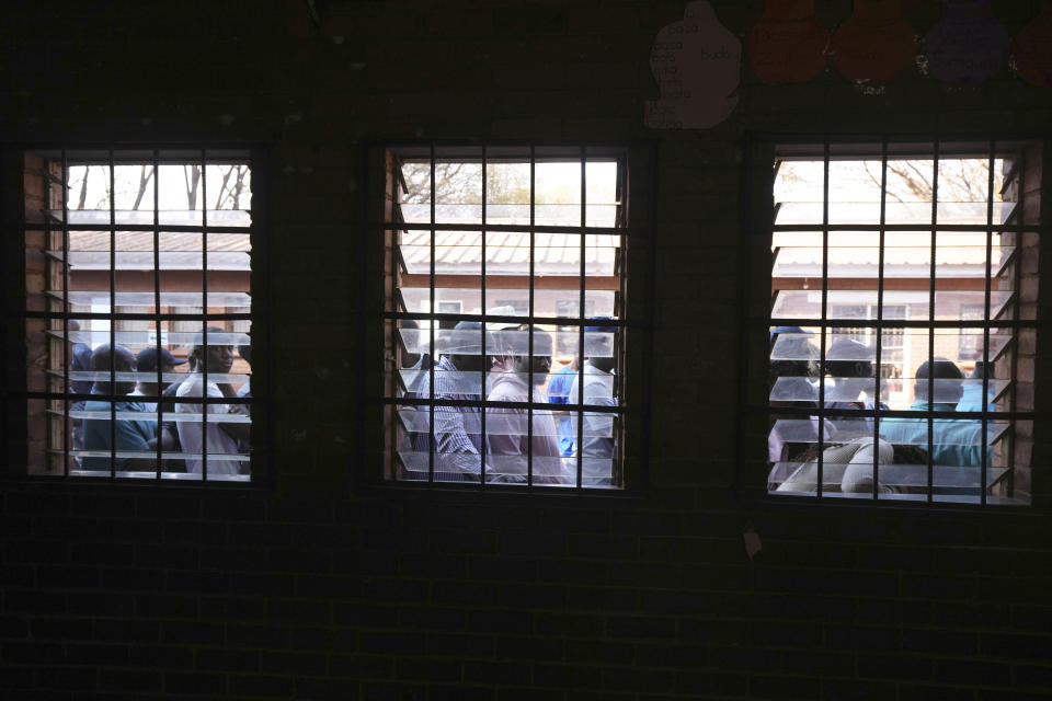 People queue to cast their votes at a polling station in Harare, Wednesday, Aug 23 2023. Polls have opened in Zimbabwe as President President Emmerson Mnangagwa seeks a second and final term in a country with a history of violent and disputed votes. (AP Photo/Tsvangirayi Mukwazhi)