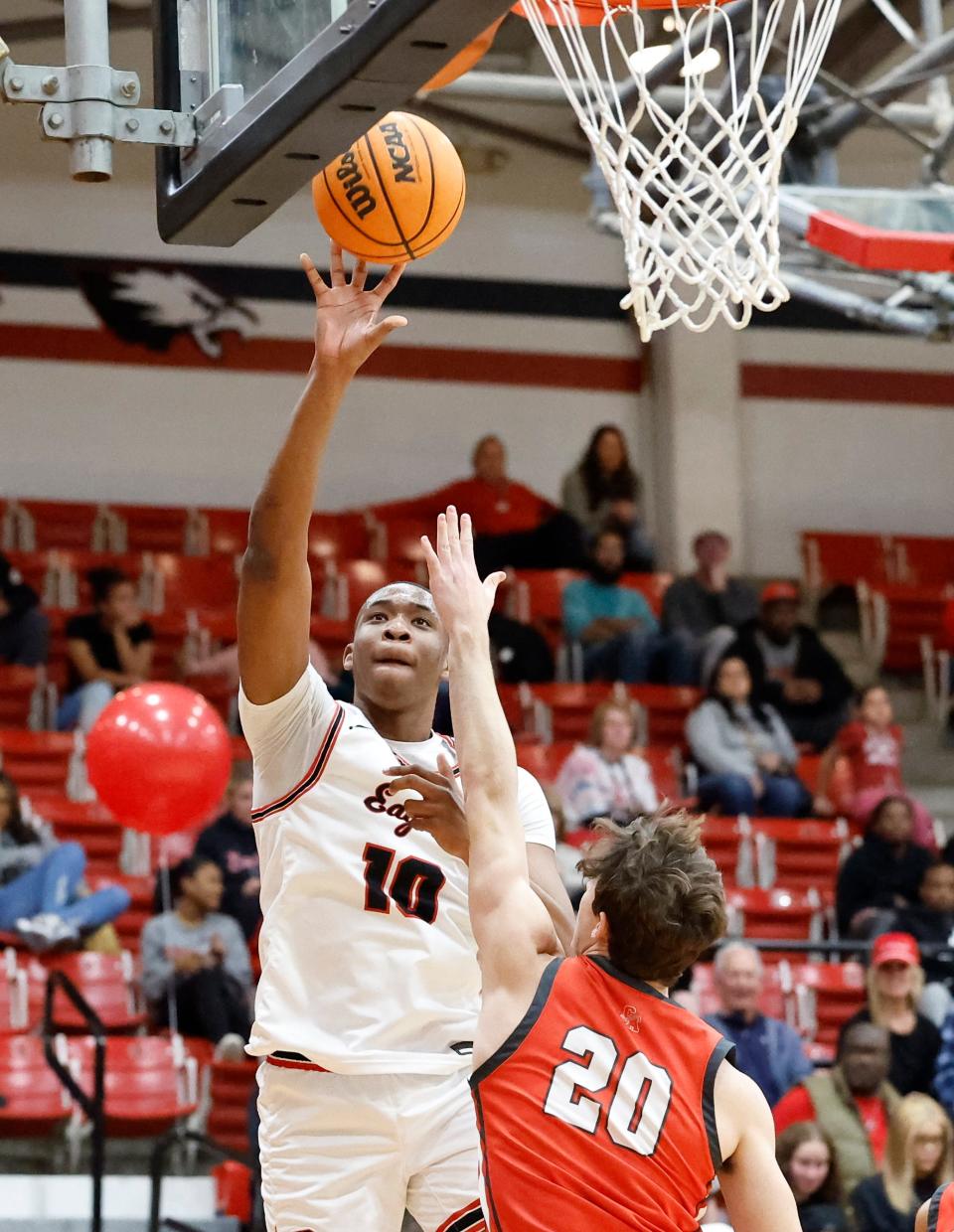 Del City's Brandon Garrison shoots over Carl Albert's Reed DeQuasie during a game in Del City on Friday.