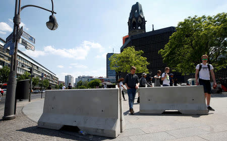 FILE PHOTO: Concrete barriers are pictured at the same site where on December 19, 2016 a truck ploughed through a crowd at a Christmas market on Breitscheidplatz square near Kurfuerstendamm avenue, ahead of the German protestant church congress (Kirchentag), in Berlin, Germany, May 23, 2017. REUTERS/Fabrizio Bensch/File Photo