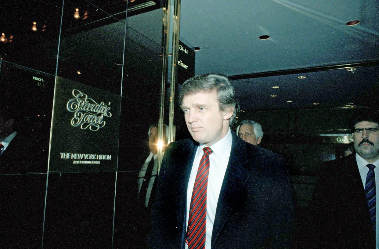 Donald Trump enters the New York Hilton Hotel, on Feb. 23, 1990, where he was honored by a business organization. 