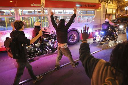 Protesters hold their hands up while marching down Market Street during a demonstration against the grand jury decision in the Ferguson, Missouri shooting of Michael Brown in San Francisco, California November 28, 2014. REUTERS/Elijah Nouvelage