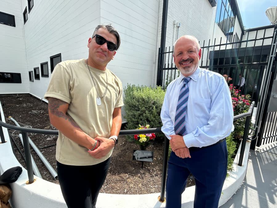 Edward Flores, who trained Kaxan and oversaw his on-air appearances, and KXAN senior forecaster Jim Spencer in front of the Kaxan garden. (KXAN Photo/Frank Martinez)