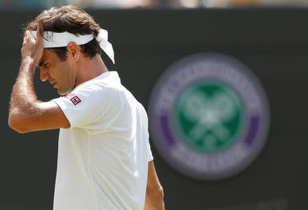 Tennis - Wimbledon - All England Lawn Tennis and Croquet Club, London, Britain - July 11, 2018. Switzerland's Roger Federer reacts during his quarter final match against South Africa's Kevin Anderson. REUTERS/Andrew Boyers