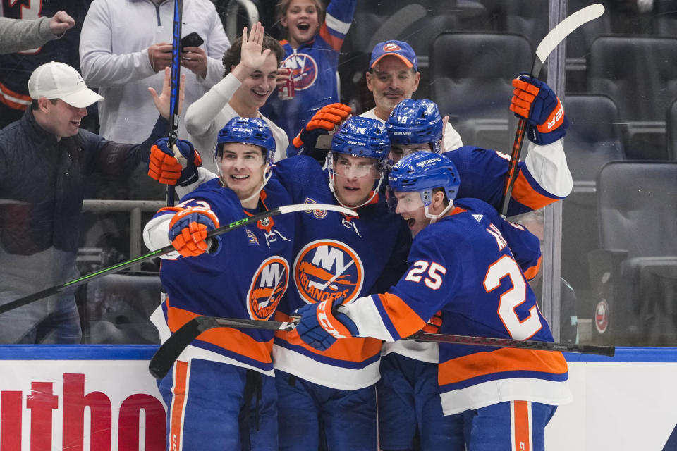 New York Islanders center Bo Horvat (14) celebrates with teammates Sebastian Aho (25) and Mathew Barzal (13) after scoring a goal during the second period of an NHL hockey game against the Seattle Kraken Tuesday, Feb. 7, 2023, in Elmont, N.Y. (AP Photo/Frank Franklin II)