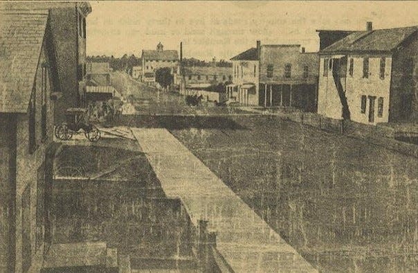 Holland prior to the Great Fire of 1871, looking north on River Avenue toward Eighth Street.