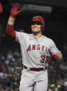 Los Angeles Angels' Max Stassi reacts after hitting a two run home run against the Arizona Diamondbacks in the first inning during a baseball game, Sunday, June 13, 2021, in Phoenix. (AP Photo/Rick Scuteri)